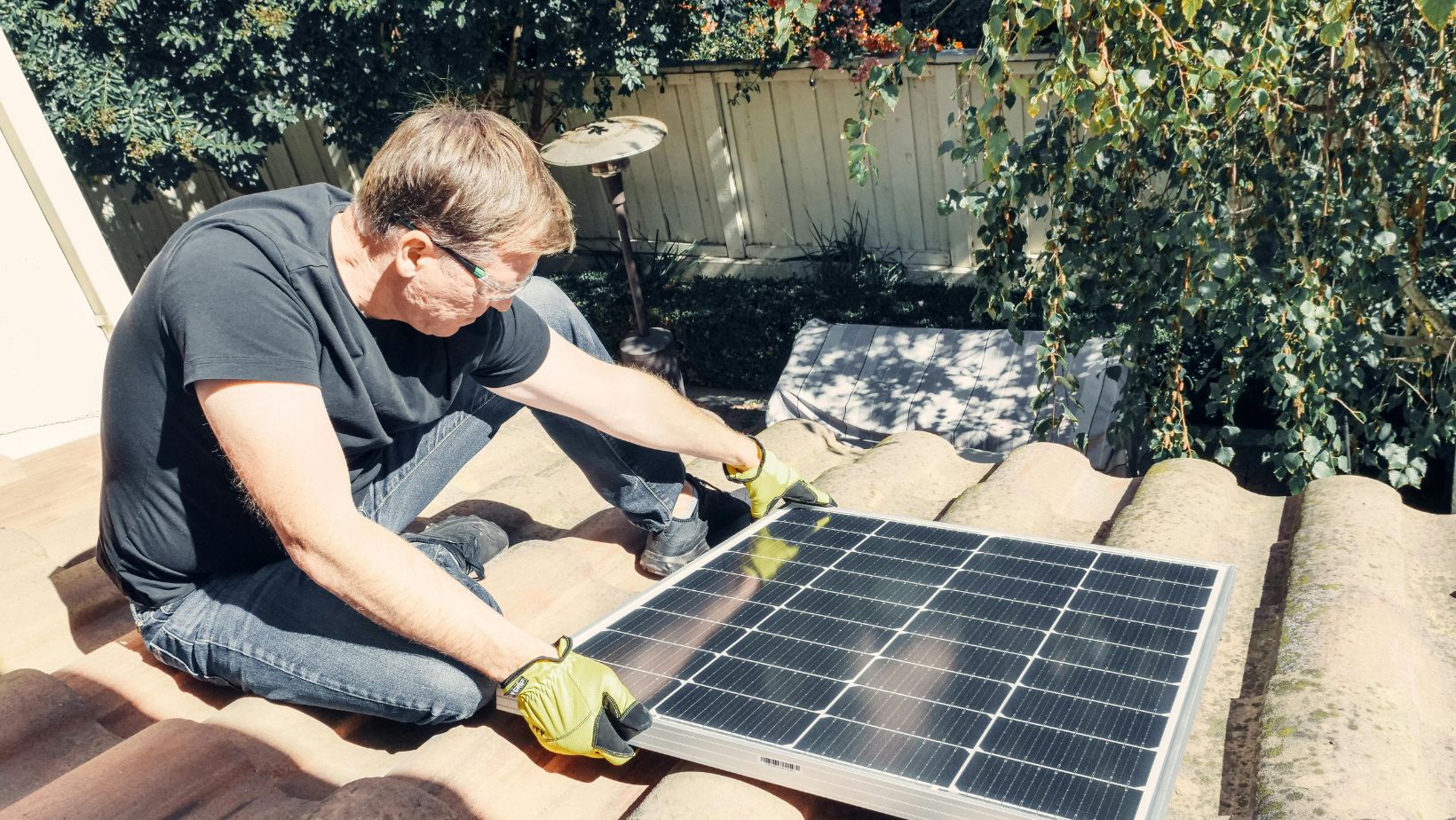 Man installing solar panel on daytime